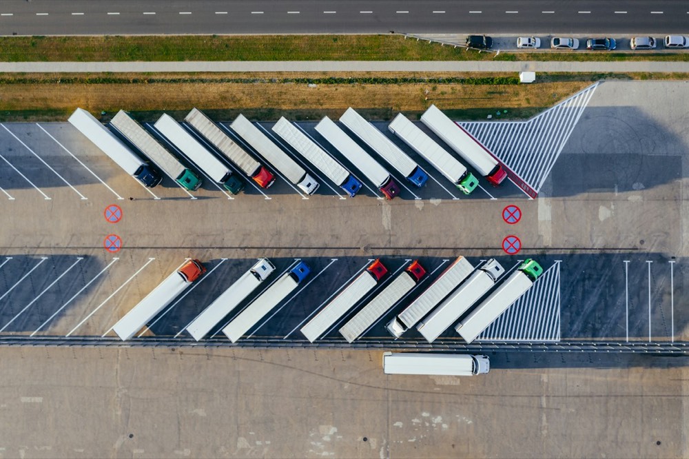 Trailers backed into a row of loading dock doors, seen from above.
