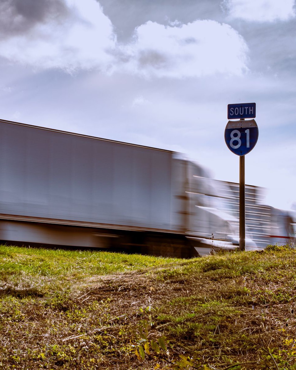 A dry van blurring south past an Interstate 81 shield.